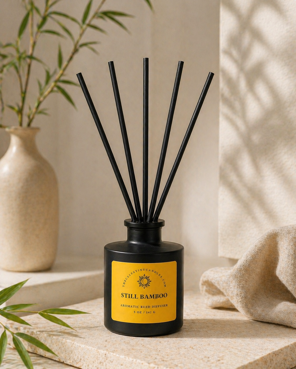 Diffuser with black sticks on a yellow label against a neutral background