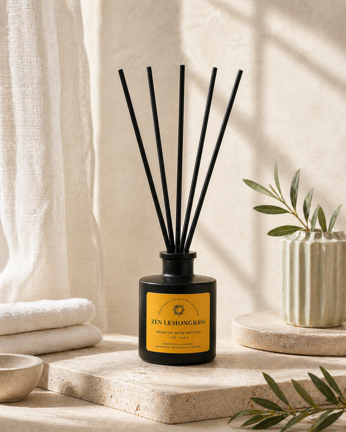 Zen Lemongrass reed diffuser in a matte black glass bottle with black reeds, styled with soft linen and greenery for a spa-inspired home fragrance display.